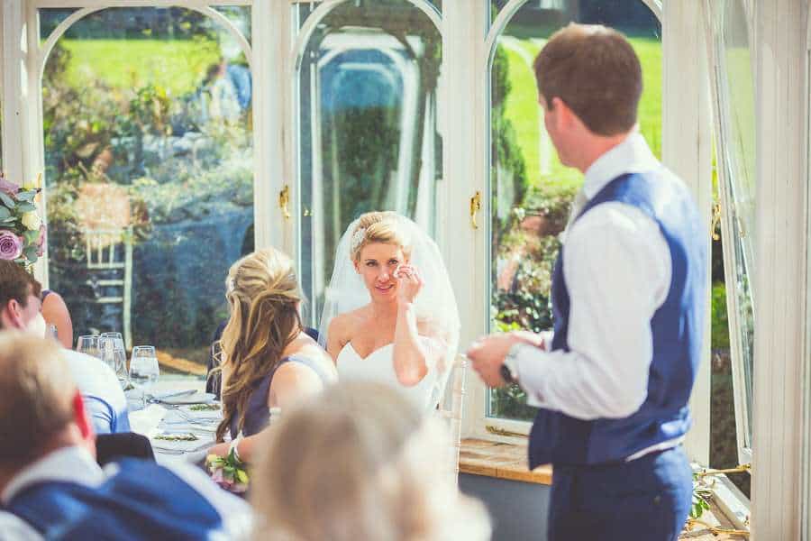 bride crying and emotional during groom speech at wedding