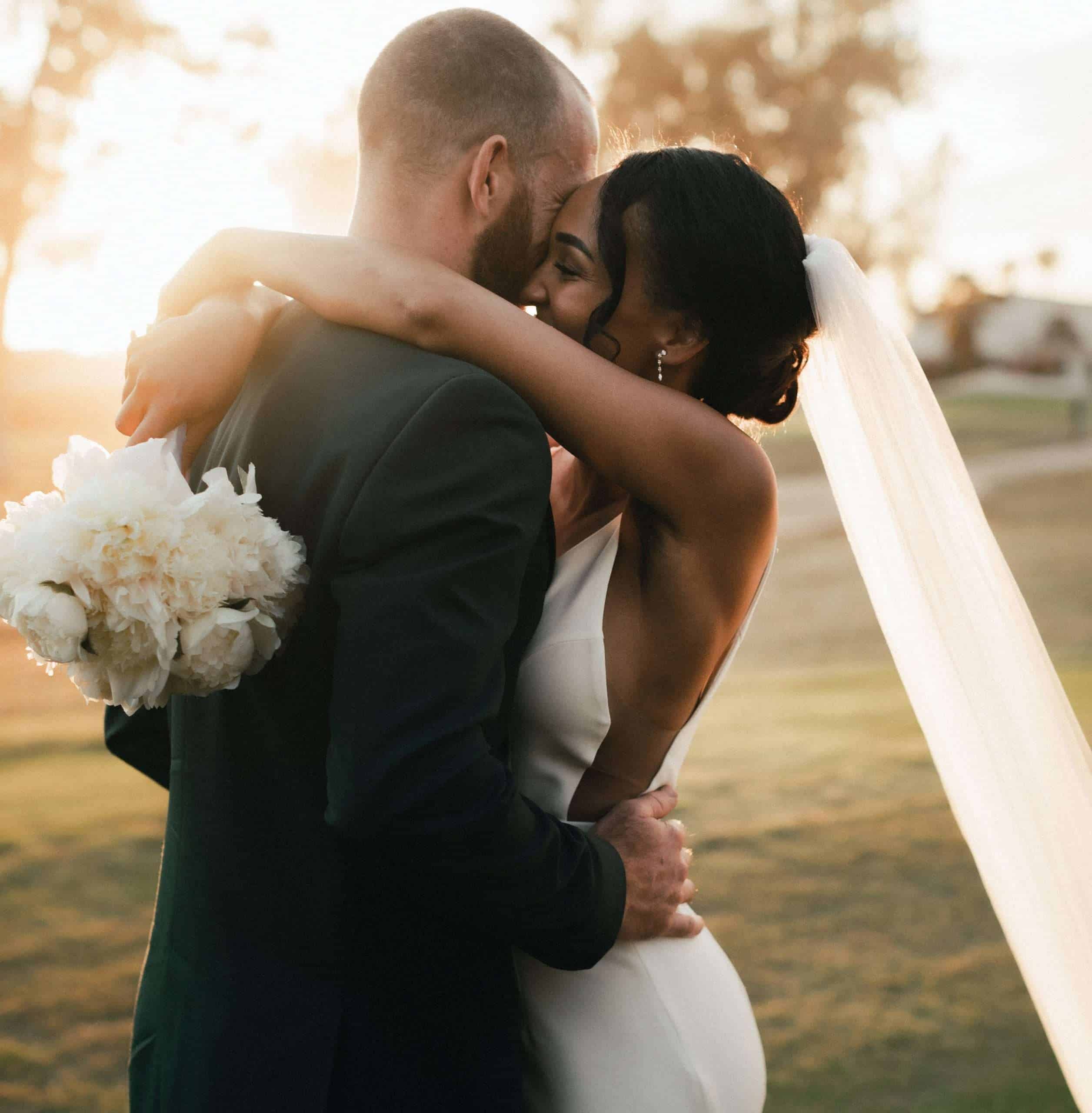 Bride and groom hugging after wedding speeches