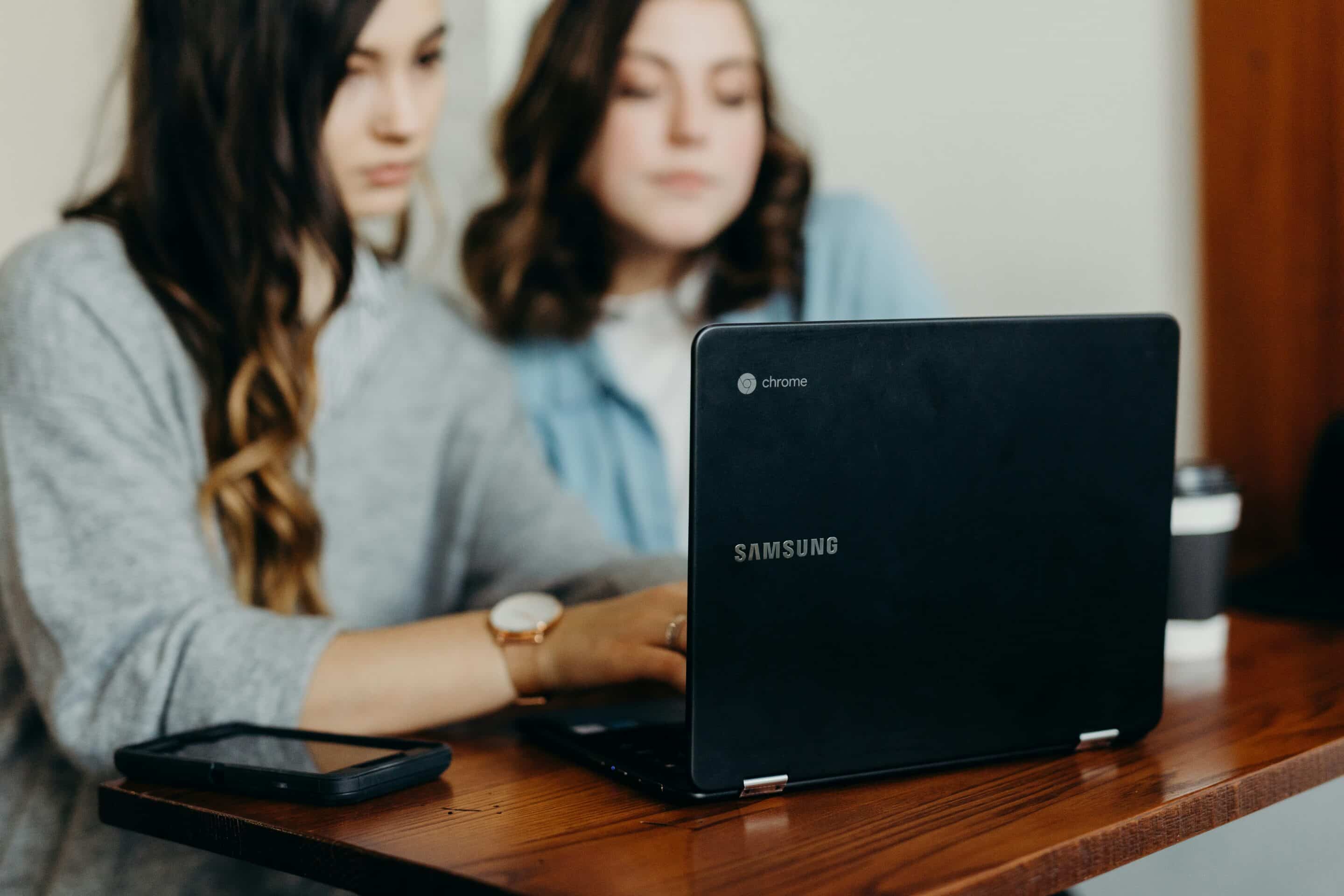 a couple typing on a laptop
