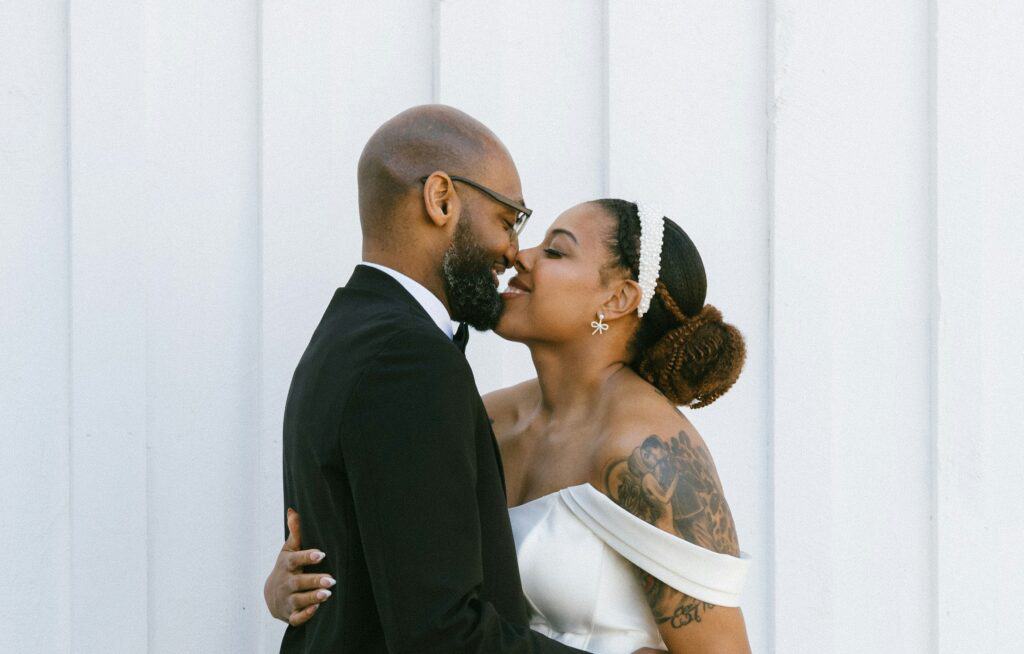black couple kissing after delivering their speech
