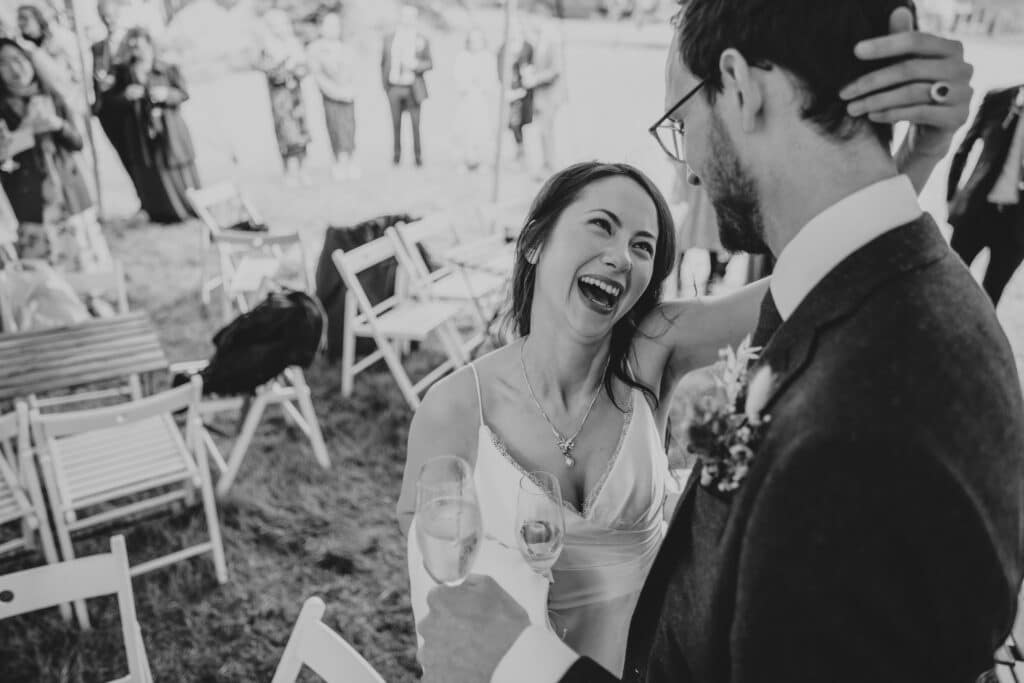bride laughing at her groom's funny speech