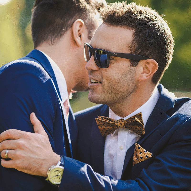 Best man hugging groom