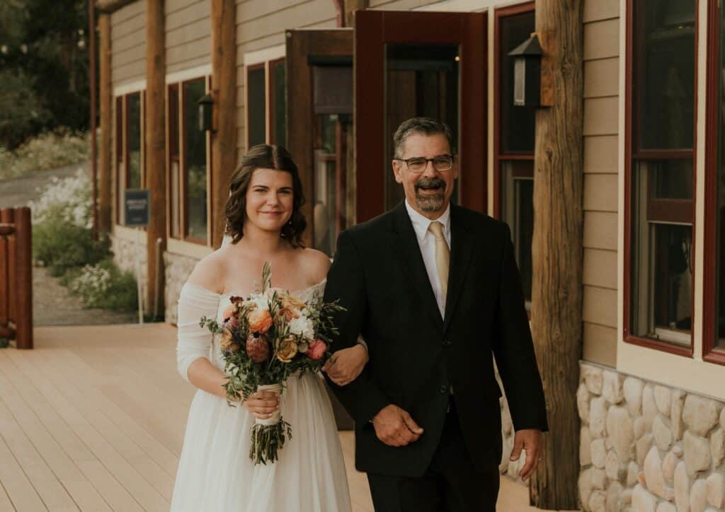 Father of the bride walking with bride
