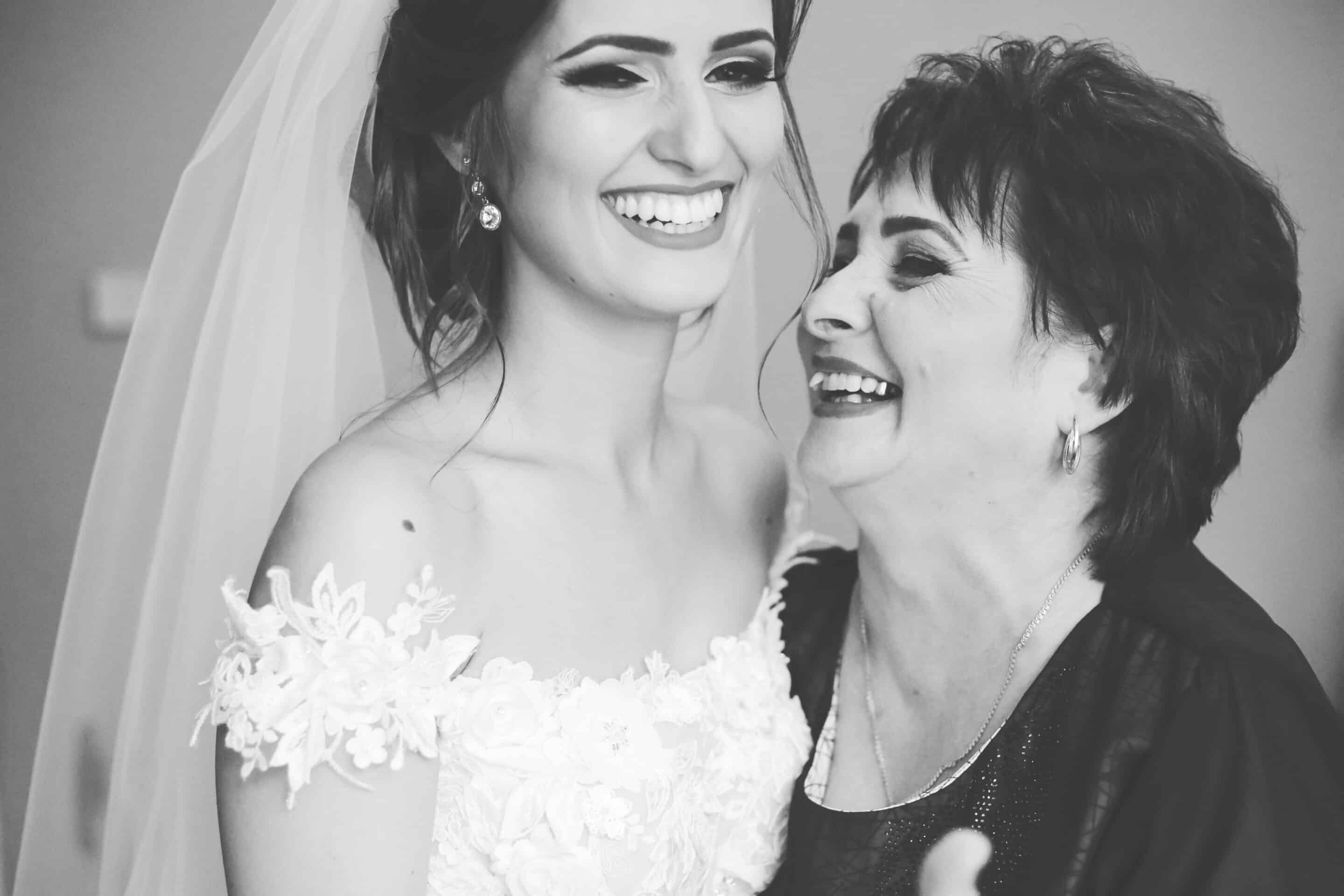 Bride and her mother smiling.