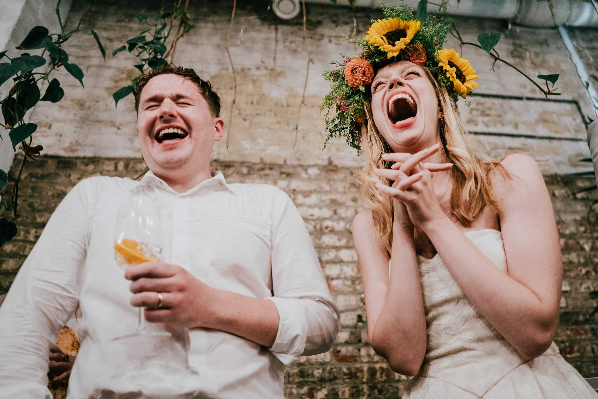 newlyweds laughing at a speech
