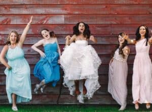 bride with maids of honour - jumping and laughing