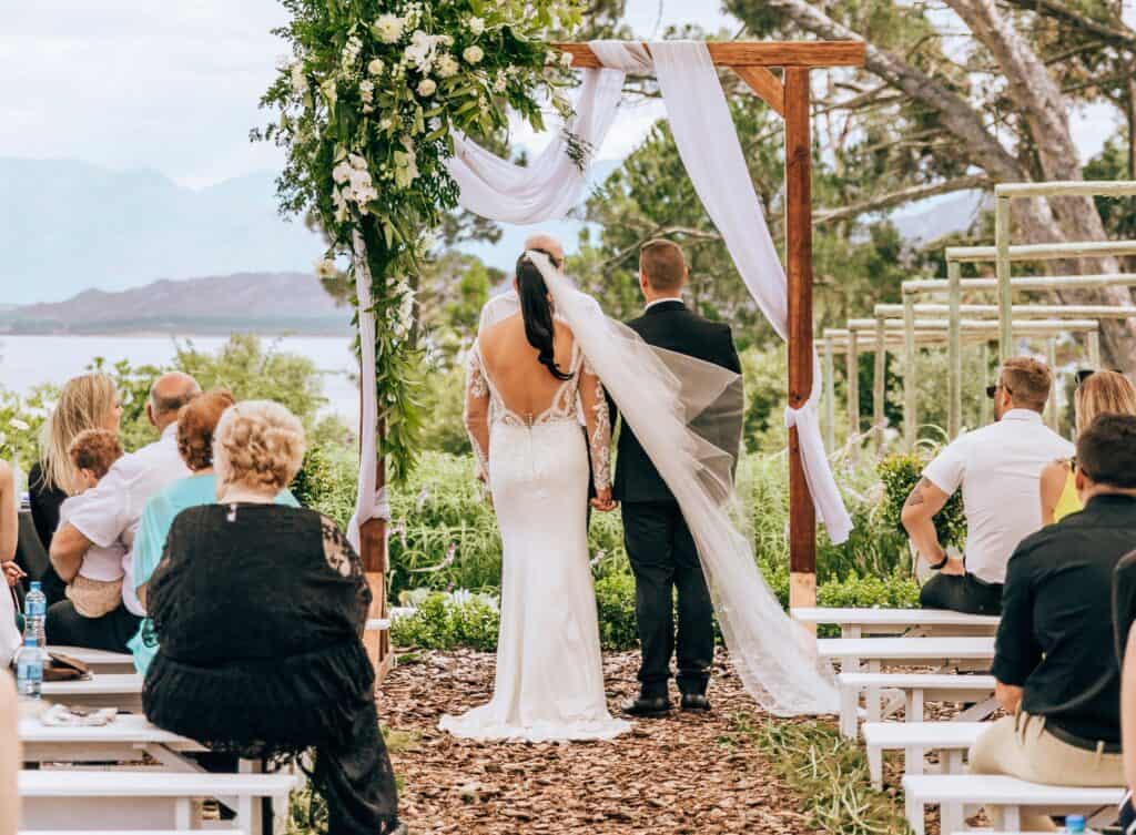 couple delivering their wedding vows in outdoor ceremony Speechy